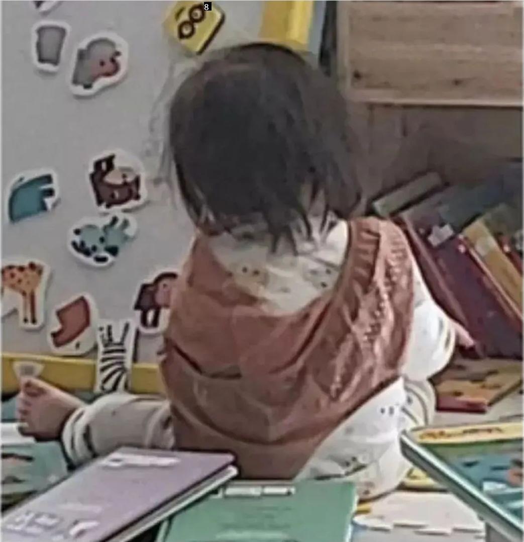 A mother surprised by a picture of her daughter sent from a daycare center