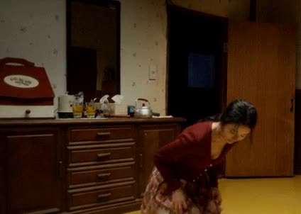 a woman mopping in a movie trap