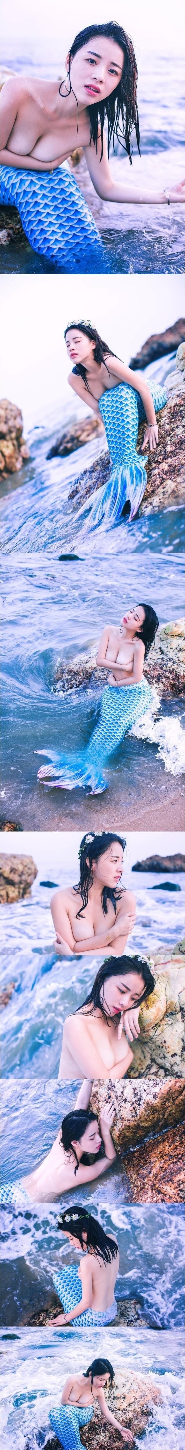 A mermaid costume play with a no bra.