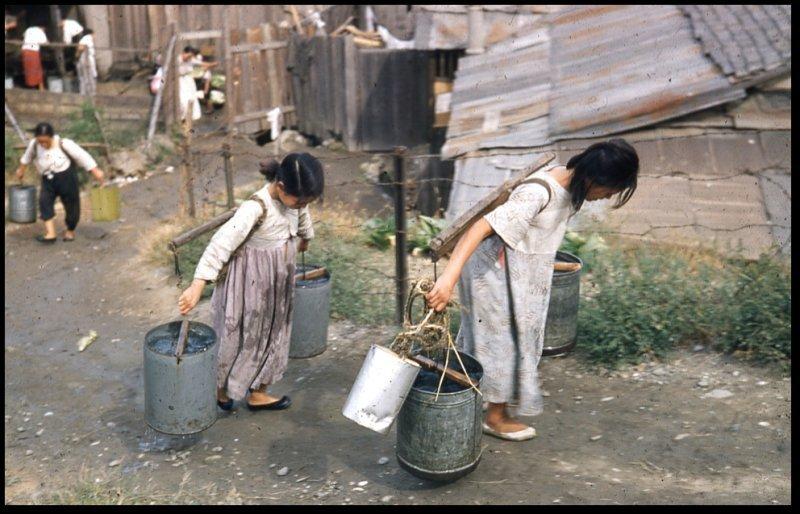 Children carrying water 70 years ago jpg