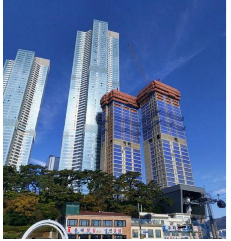 An overnight concrete view of a 69th floor residential and commercial complex in Busan