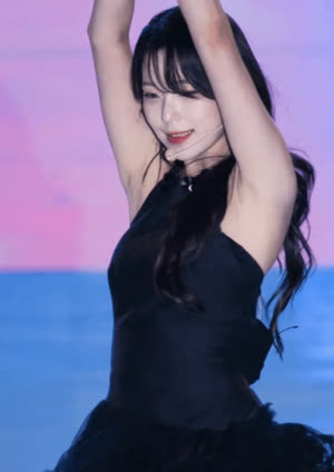 Fromis Nine Baek Ji-heon wears a black sleeveless dress and raises both arms