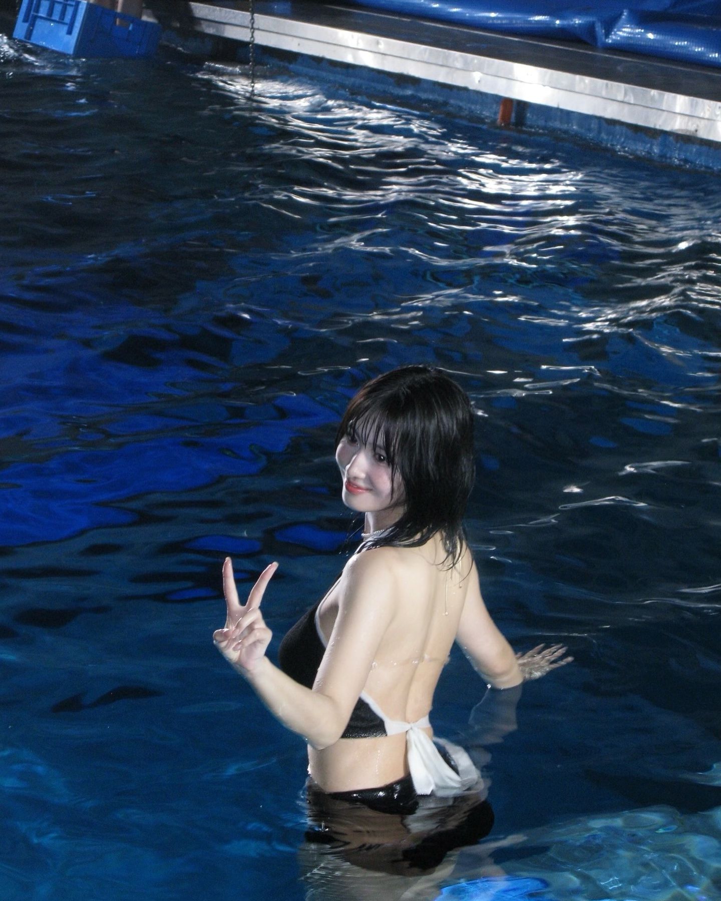 Twice Momo's black two-piece swimsuit with a solid body while scuba diving