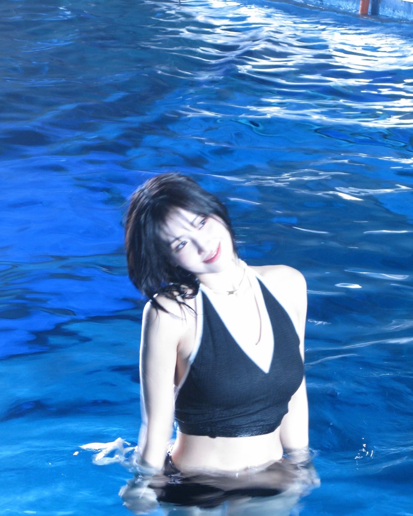 Twice Momo's black two-piece swimsuit with a solid body while scuba diving