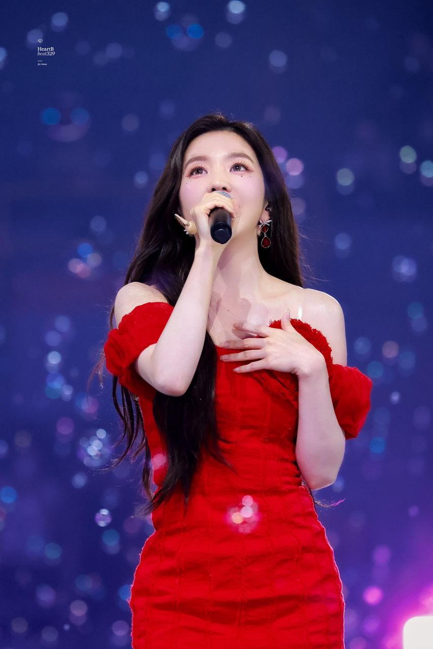 Red Velvet Irene going up the stairs red off-shoulder mini dress hips