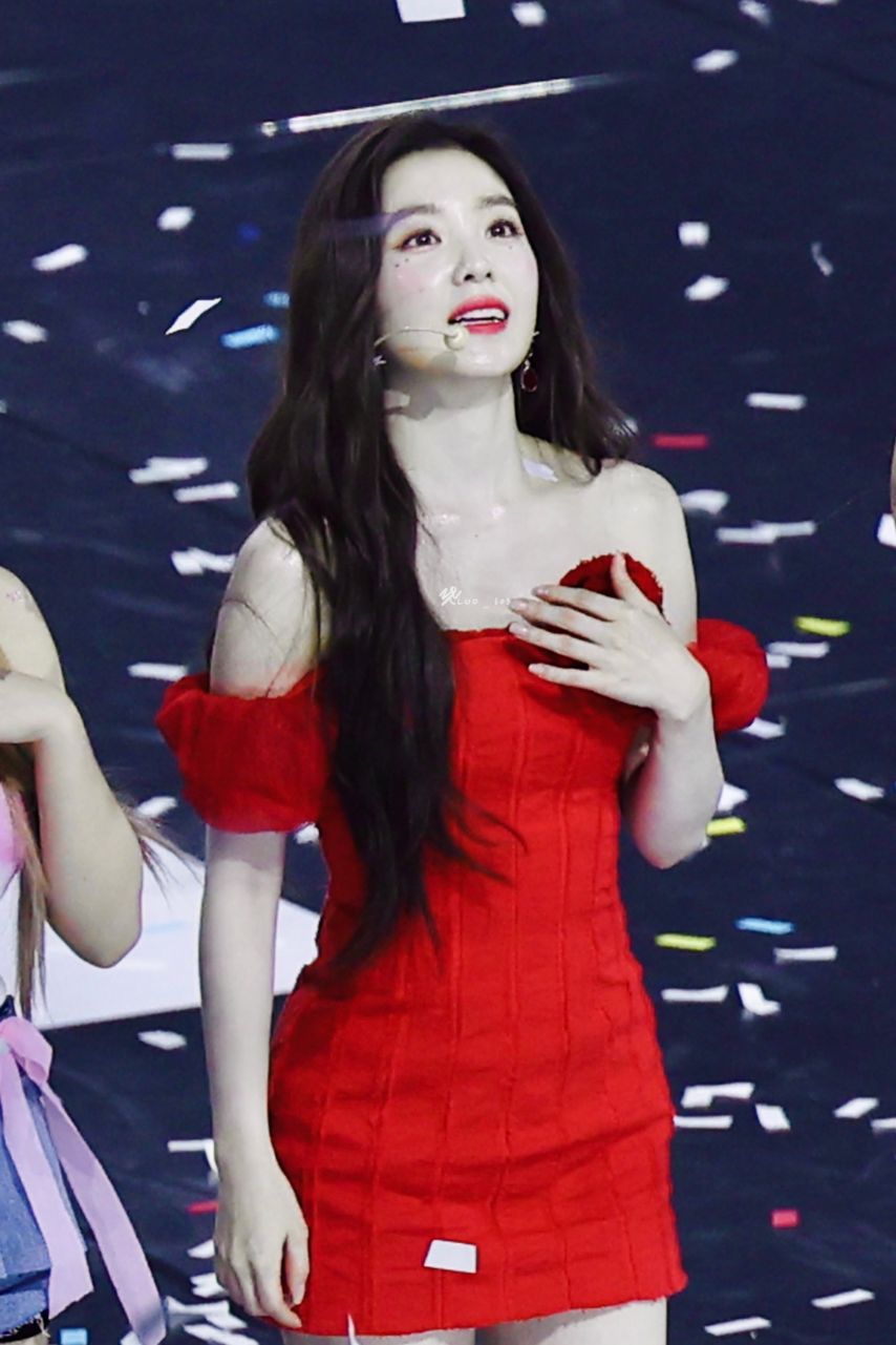 Red Velvet Irene going up the stairs red off-shoulder mini dress hips