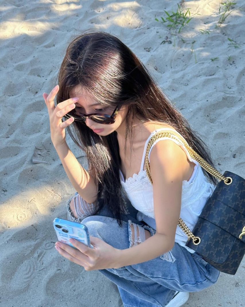 Kang Hye-won's subtle cleavage taken from above in a lace white string tank top