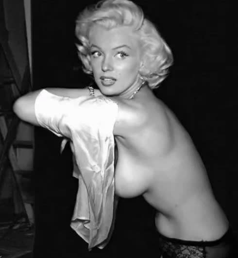 Marilyn Monroe topless, covering only the top