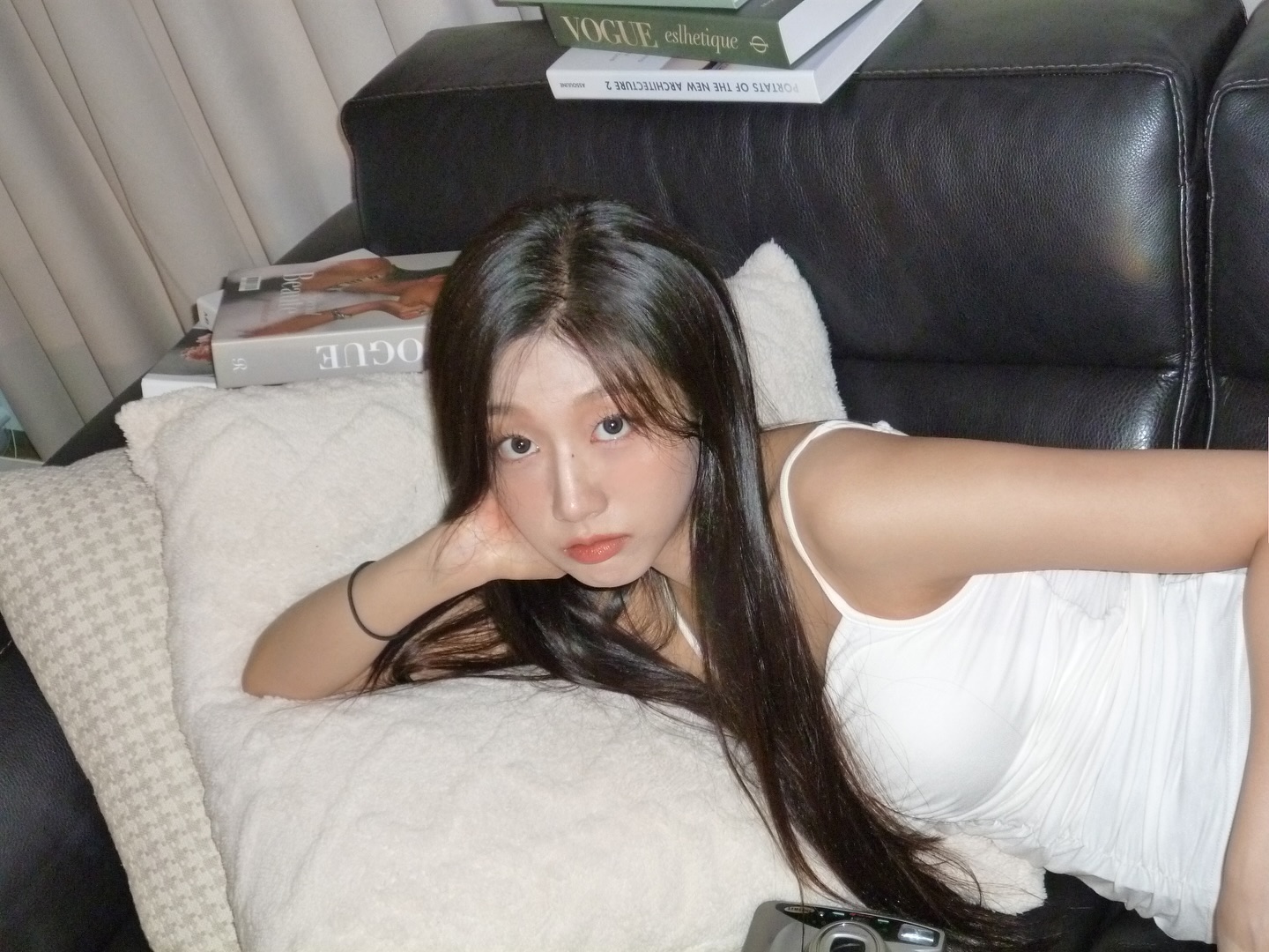 Lovelyz's Jeong Yein's body lying on the sofa wearing a puffy white thong tank top - Instagram