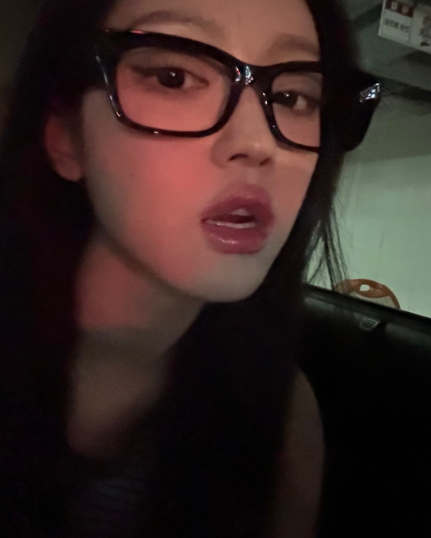 Oh My Girl's toddler wearing horn-rimmed glasses sticks out tongue with thick lips