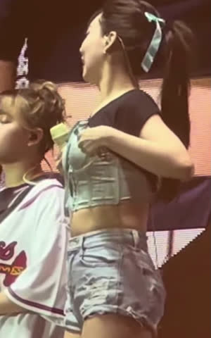 Twice Nayeon's light blue corset pulled up bra strap seen from the side