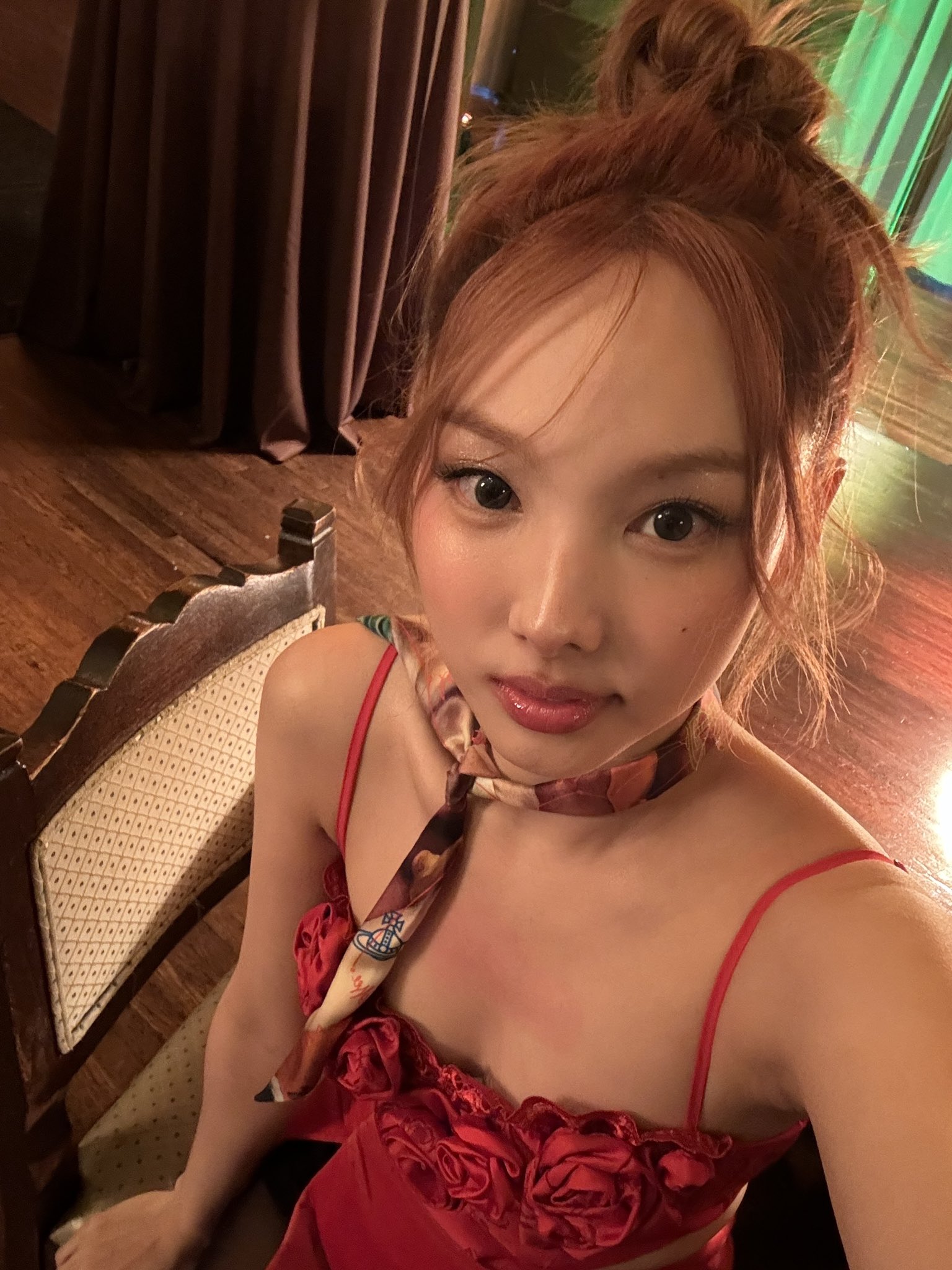 TWICE Nayeon's cleavage seen from above in red string tank top