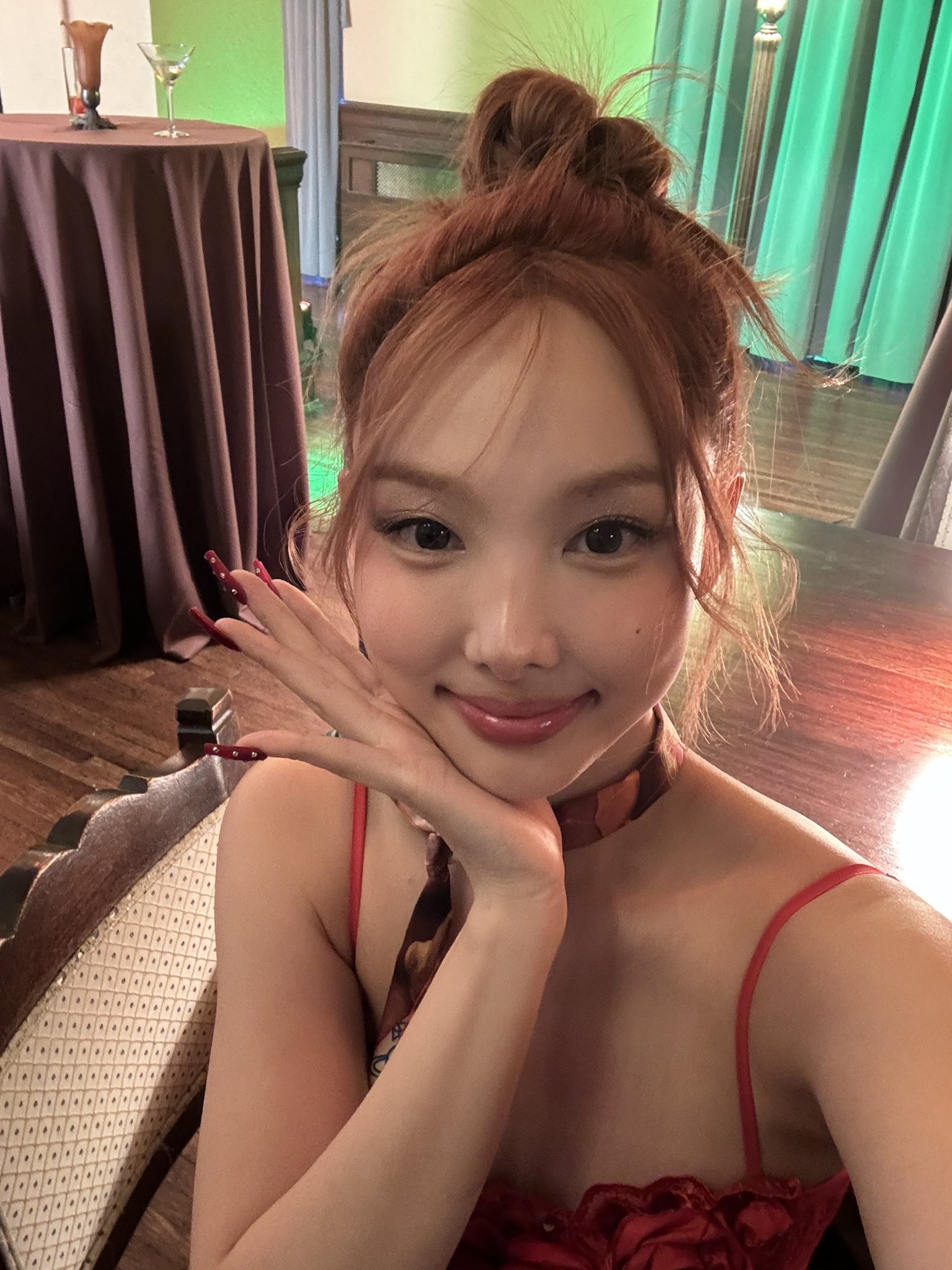 TWICE Nayeon's cleavage seen from above in red string tank top