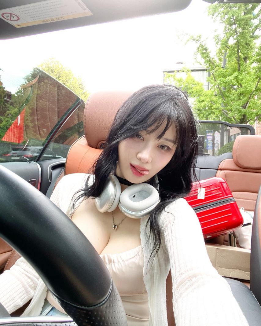 Kim Woo-hyun driving a convertible with heavy cleavage