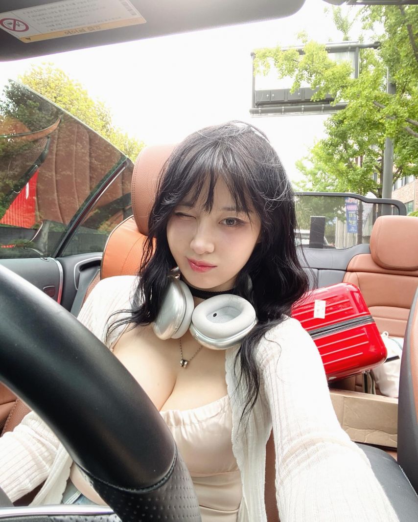 Kim Woo-hyun driving a convertible with heavy cleavage